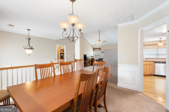 dining area with a textured ceiling, a healthy amount of sunlight, light colored carpet, and ceiling fan with notable chandelier