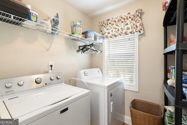 clothes washing area featuring washing machine and dryer and a textured ceiling