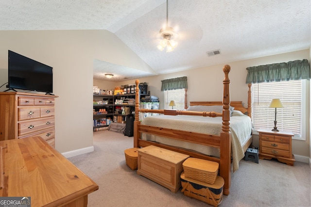 bedroom with a textured ceiling, light carpet, ceiling fan, and lofted ceiling