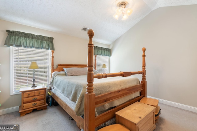 carpeted bedroom with lofted ceiling and a textured ceiling