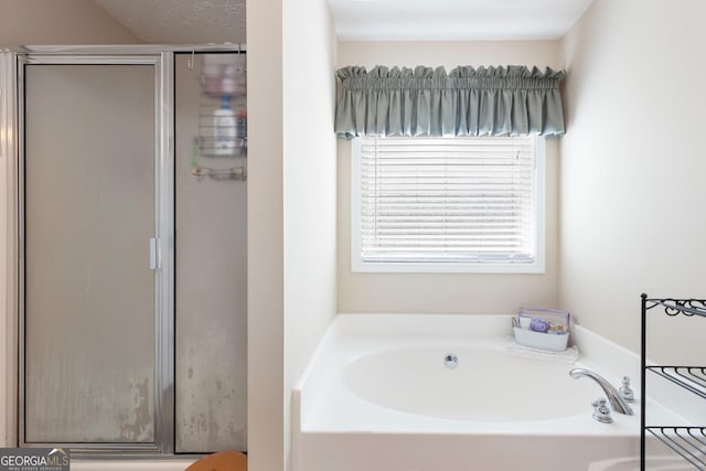 bathroom featuring plus walk in shower