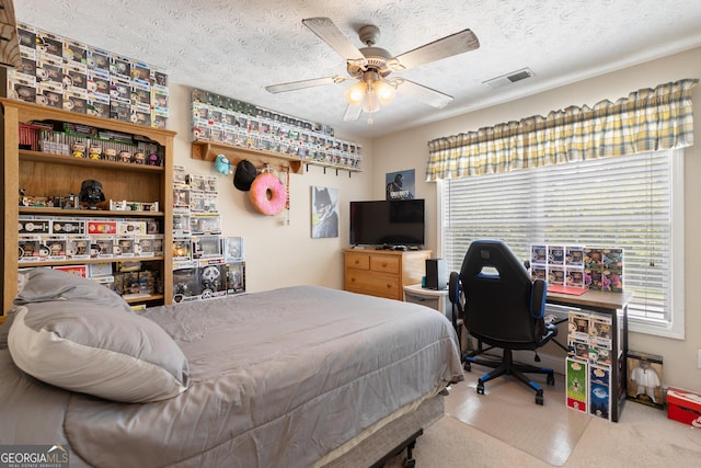 carpeted bedroom with multiple windows, ceiling fan, and a textured ceiling