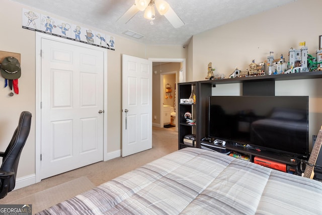 bedroom with light carpet, a textured ceiling, and ceiling fan