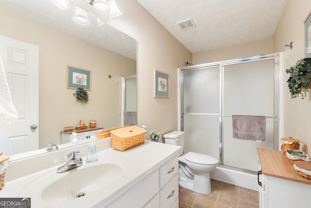 bathroom with vanity, a textured ceiling, toilet, and walk in shower