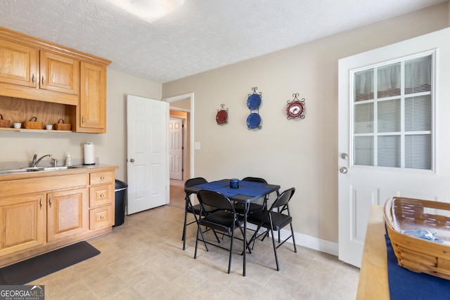 dining area with a textured ceiling and sink