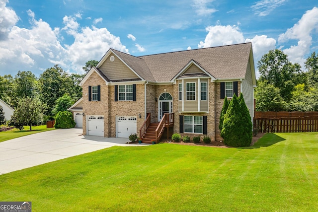 bi-level home featuring a front yard and a garage