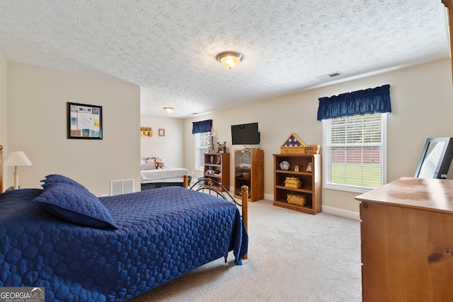 carpeted bedroom featuring a textured ceiling