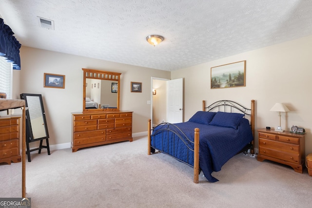 carpeted bedroom with a textured ceiling