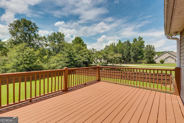 wooden terrace with a lawn