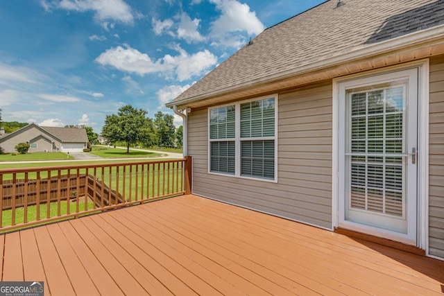 wooden terrace with a yard