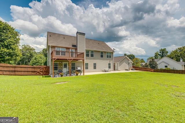 rear view of house with a patio area, a yard, and a deck