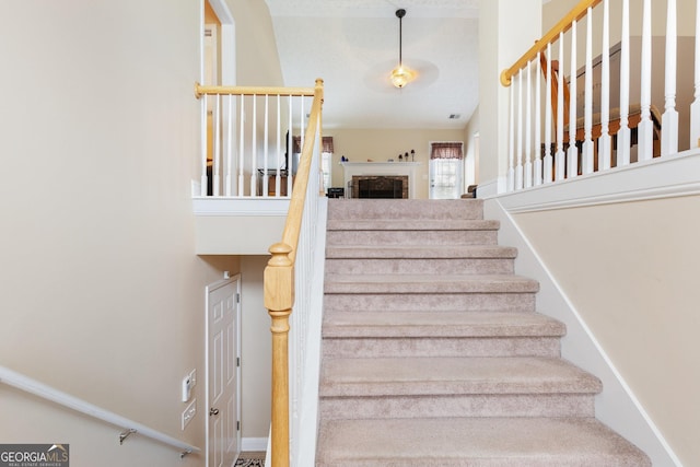 staircase with a towering ceiling