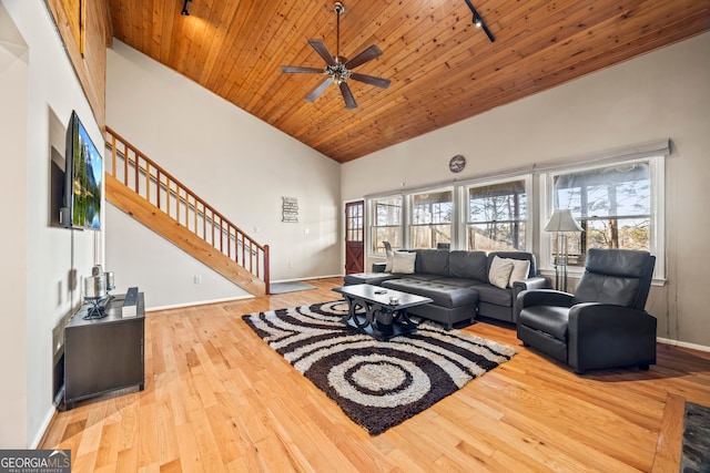 living room with ceiling fan, rail lighting, wooden ceiling, light hardwood / wood-style flooring, and high vaulted ceiling