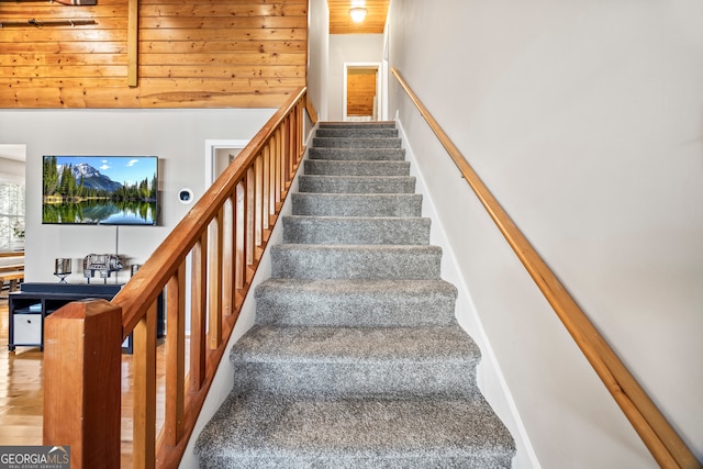 stairway with vaulted ceiling and wood ceiling