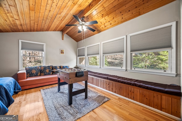 playroom featuring hardwood / wood-style floors, lofted ceiling with beams, ceiling fan, and wooden ceiling