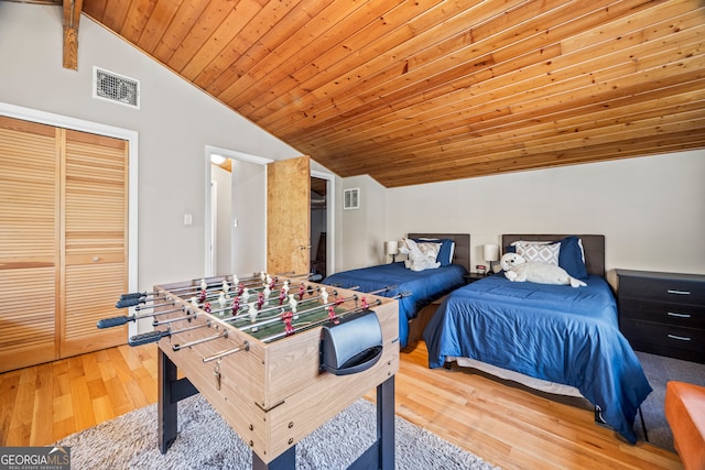 bedroom with vaulted ceiling with beams, wood-type flooring, wood ceiling, and a closet