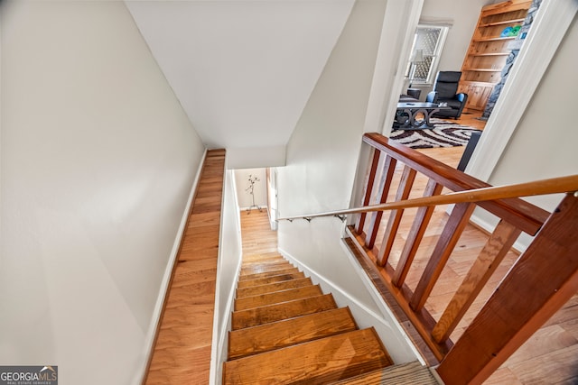 stairs with hardwood / wood-style flooring