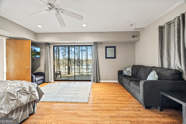 bedroom featuring access to exterior, light wood-type flooring, and ceiling fan