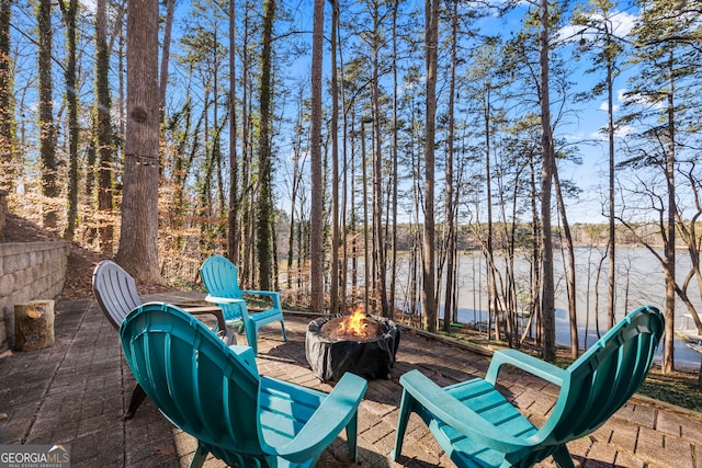 view of patio featuring a water view and an outdoor fire pit