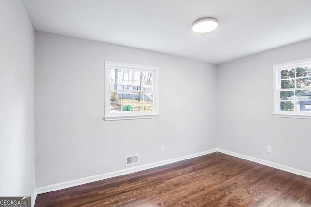 empty room with dark hardwood / wood-style floors