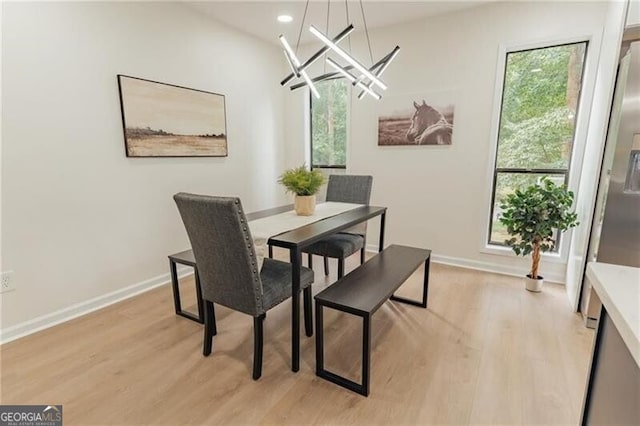 dining room featuring a notable chandelier and light wood-type flooring