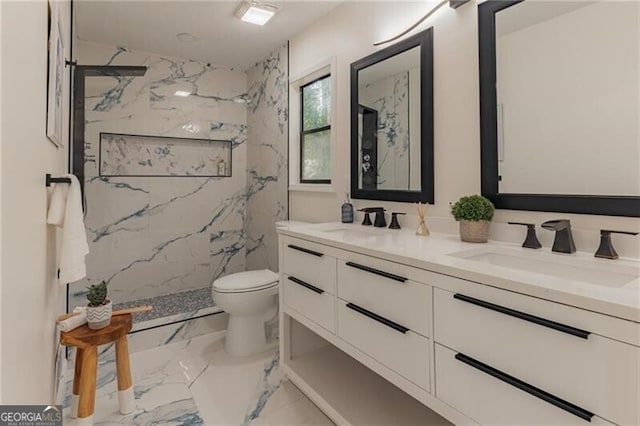 bathroom featuring tiled shower, vanity, and toilet