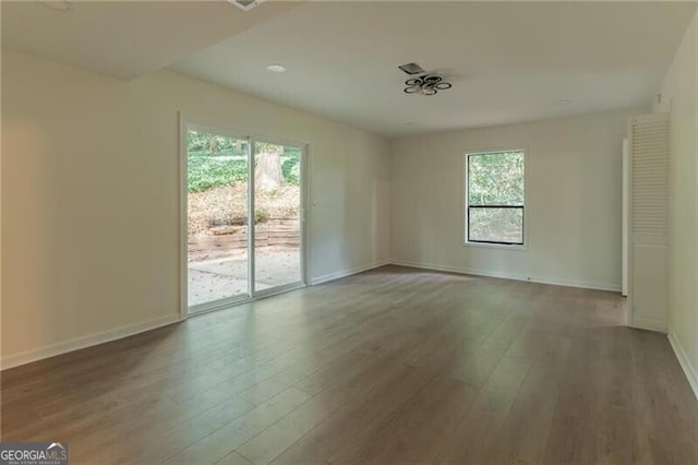 spare room with hardwood / wood-style floors and a wealth of natural light