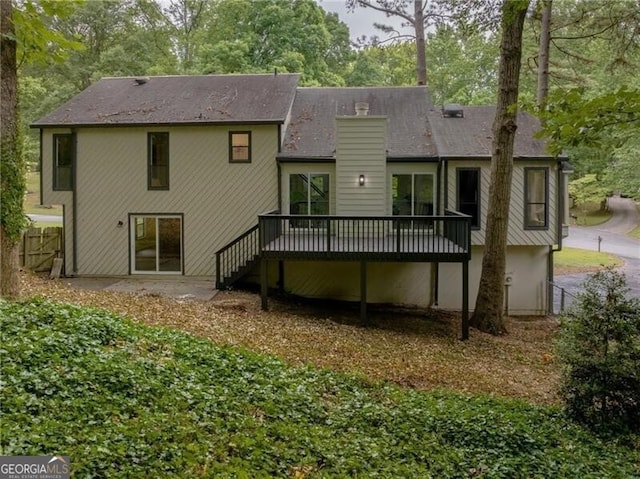 rear view of house with a wooden deck