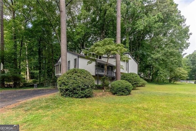 view of property exterior featuring a lawn