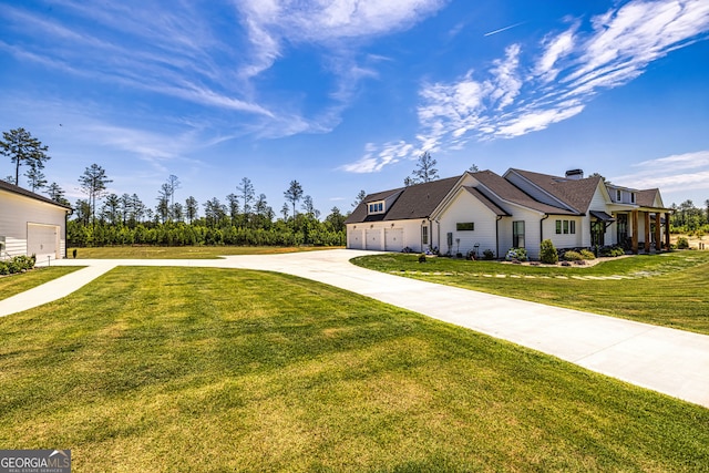 view of front of home featuring a front yard and a garage