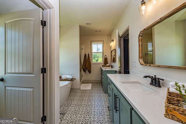 bathroom with a bathing tub, tile patterned flooring, and vanity