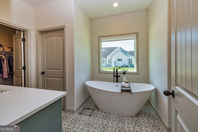 bathroom with tile patterned floors and a tub