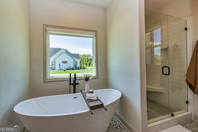 bathroom featuring tile patterned flooring and shower with separate bathtub