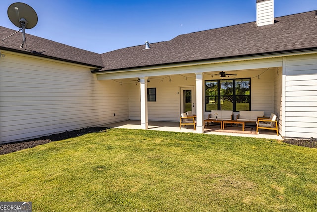 back of house featuring a lawn, an outdoor living space, ceiling fan, and a patio