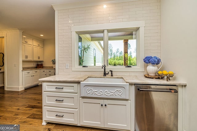 kitchen featuring dark hardwood / wood-style flooring, light stone counters, sink, and stainless steel dishwasher