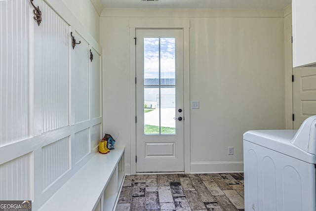 washroom featuring washer / clothes dryer, a water view, and cabinets