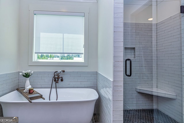 bathroom with independent shower and bath and tile walls