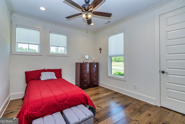 bedroom featuring hardwood / wood-style floors, ceiling fan, and crown molding