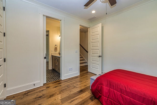 bedroom with hardwood / wood-style flooring, ceiling fan, ornamental molding, and ensuite bath