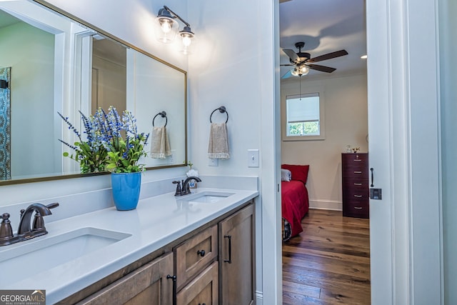 bathroom with hardwood / wood-style floors, vanity, and ceiling fan