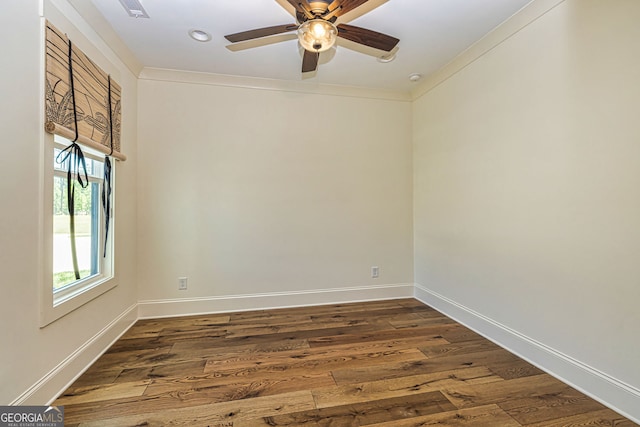 empty room with crown molding, ceiling fan, and dark hardwood / wood-style floors