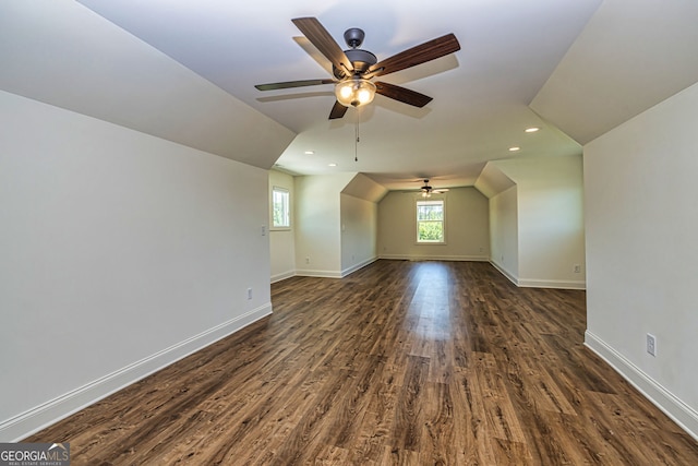 bonus room featuring dark hardwood / wood-style flooring, vaulted ceiling, and ceiling fan