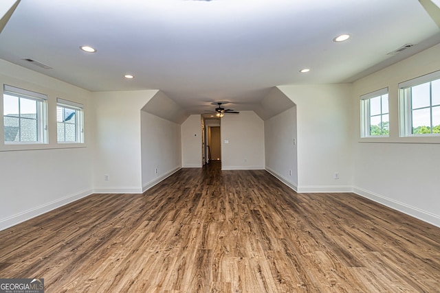 additional living space with vaulted ceiling, ceiling fan, and dark wood-type flooring