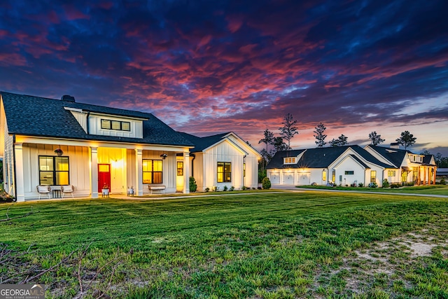 modern farmhouse style home with a lawn