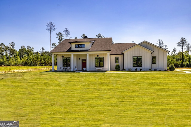 view of front of home with covered porch and a front yard