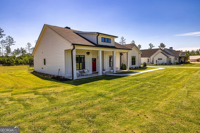 view of front of property with a porch and a front lawn