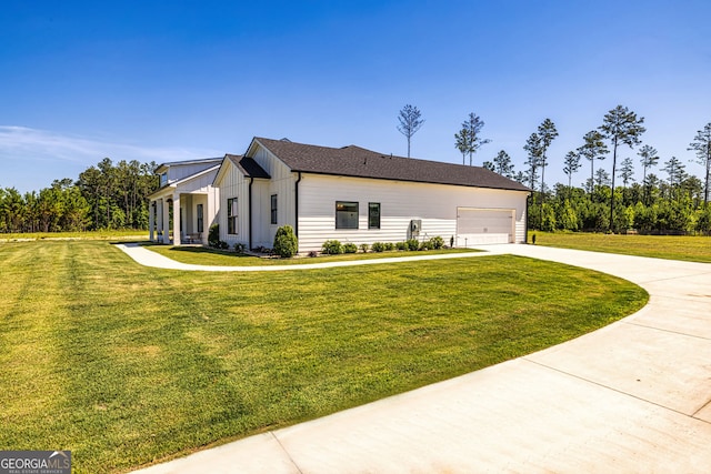 view of side of home featuring a lawn and a garage