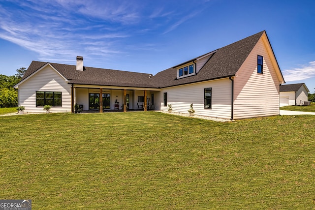 back of house featuring a lawn