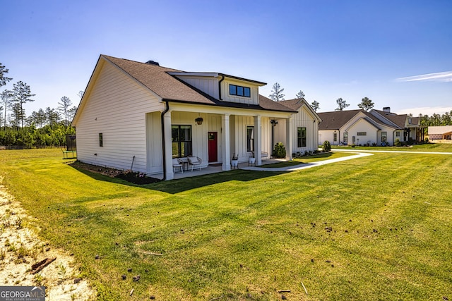 view of front of home featuring covered porch and a front yard