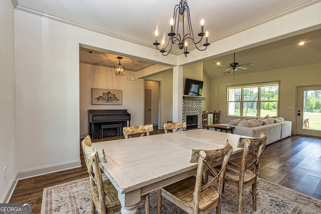 dining space featuring dark hardwood / wood-style floors, crown molding, and ceiling fan with notable chandelier